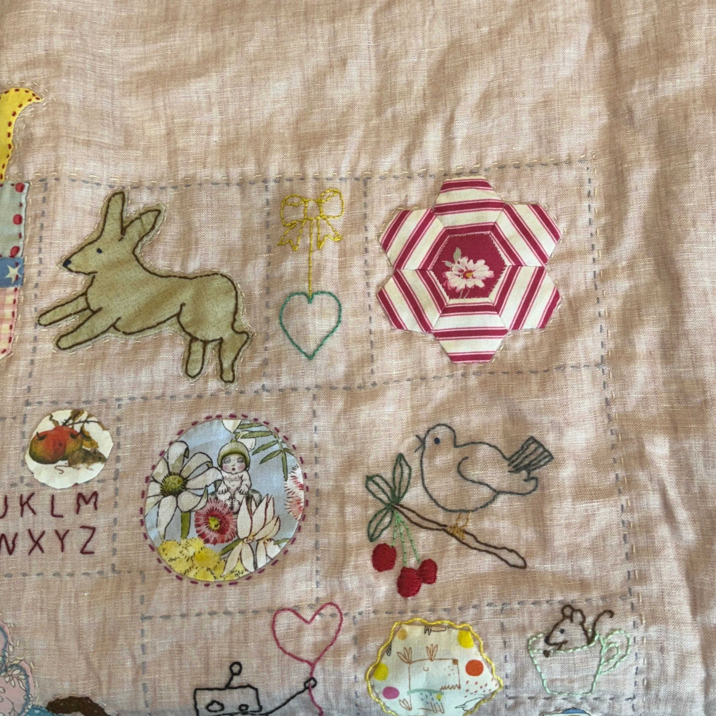 Pink toned hand stitched baby quilt